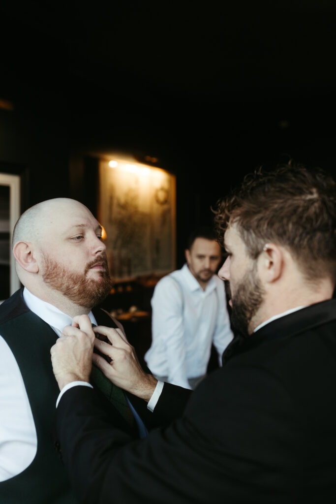 Groomsmen getting groom ready for wedding
