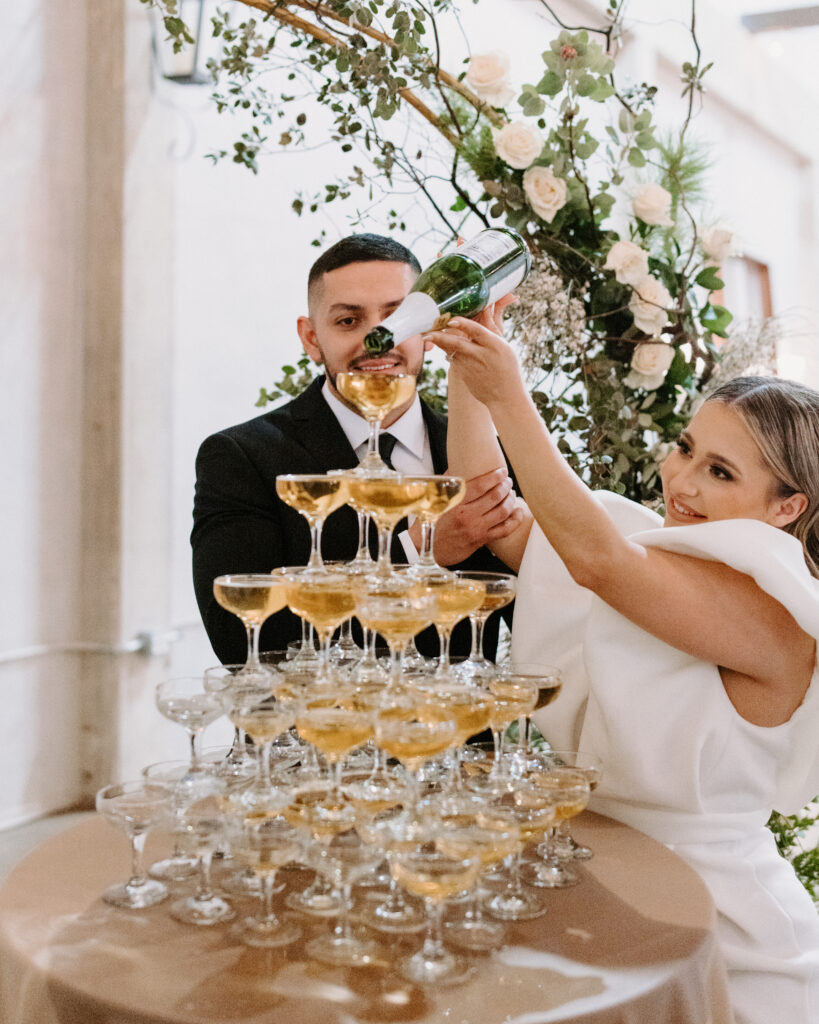 The Editorial Experience Styled Shoot: Couple enjoying their champagne tower at The Willow Ballroom