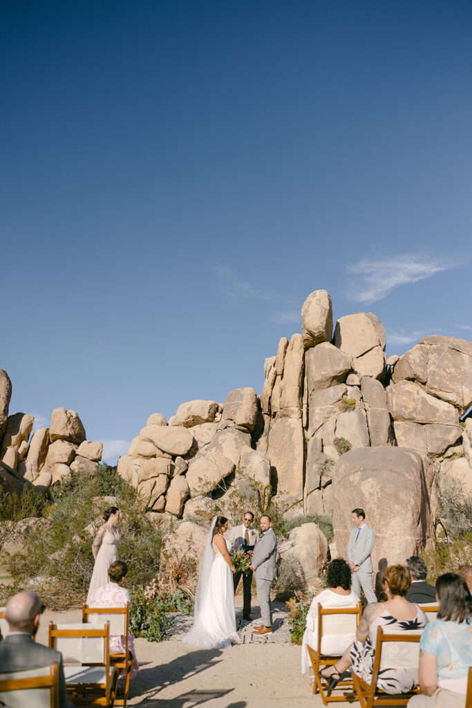 Cameron + Rick standing at the altar during ceremony in Joshua Tree